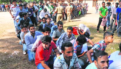 Aspirants line up to submit forms for the posts of constable in Jammu on Wednesday.