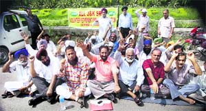 Former SRTC employees protest in front of the exhibition ground in Jammu on Wednesday.