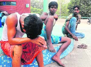 Anxious moments: Despondent fellow workers outside the trauma centre at the PGI.