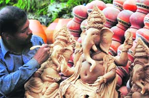 An artist giving the final touches to an idol of Lord Ganesha in Chandigarh. Ganesh Chaturthi will be celebrated on September 19.