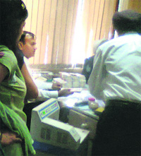 Police officials count cash recovered from Fizas locker