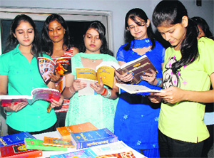 Students look at books on display after an interactive session at MCM College in Chandigarh on Thursday.