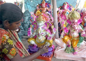 An artiste giving finishing touches to clay idols of Ganesh ahead of the Ganesh Chaturthi festival in New Delhi on Thursday. 