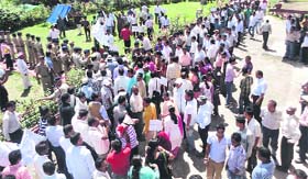 Striking government employees hold a protest against reservation in promotions outside the office of the District Magistrate in Pithoragarh on Thursday