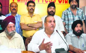Representatives of the Wholesale Shoes Merchant Association talk to mediapersons in Jalandhar on Wednesday