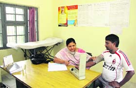 A doctor examines a patient at the centre