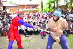 Artistes enact a scene from play Na Pursaan at Budgam on Thursday. A Tribune Photograph 