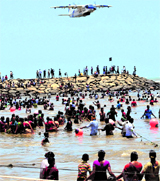 A Coast Guard aircraft flies over the activists standing in the Bay of Bengal in protest against the Kudankulam atomic power plant on Thursday.
