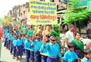Students and staff of Nalanda Elementary School take out a protest march in Amritsar on Friday.