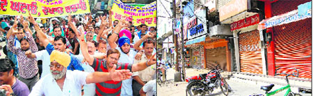 Members of the Wholesale and Retail Shoe Merchants Association hold a protest; and (right) closed shops of footwear in Amritsar on Friday