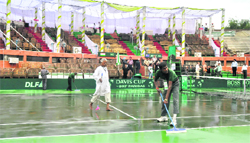 Workers drain out water from a tennis court at the CLTA in Chandigarh on Friday. 