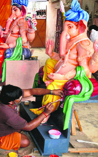 An artist gives the finishing touches to a Ganesh idol ahead of Ganeshotsav in Haridwar. 