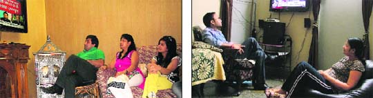 Family members of Badish Jindal; and (right) Kuldeep Singh Sikarwar catch up with the latest news on diesel prices in Ludhiana.