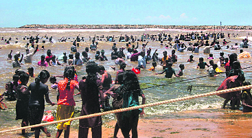 Activists and residents stand in the Bay of Bengal waters as they protest in Kudankulam on Friday.
