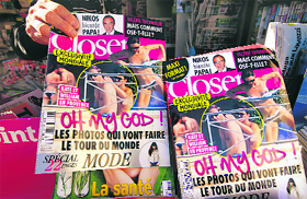 A man holds a copy of French magazine Closer showing pictures of Catherine, Duchess of Cambridge, and Britains Prince William in Nice.