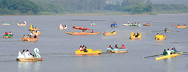 Tourists enjoy boating at the Sukhna Lake in Chandigarh on Saturday.
