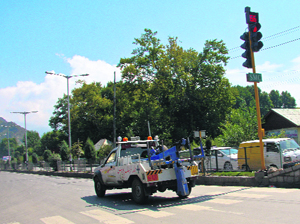 A traffic police crane jumps the red light signal at an intersection in Srinagar.