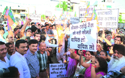 BJP activists take part in a protest demonstration against the hike in diesel prices and rationing of LPG cylinders in Ludhiana.