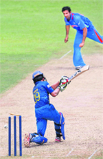Irfan Pathan bowls out Sri Lanka's Jeewan Mendis during the practice tie in Colombo on Saturday.  AP/PTI