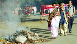 Burning garbage greets tourists during the Heritage Walk in Amritsar.