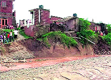 Houses that were damaged due to a flooded seasonal rivulet at Nada village in Panchkula on Sunday