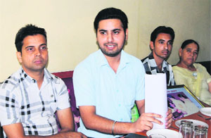 Employees under the Sarv Siksha Abhiyan address mediapersons in Amritsar on Sunday.