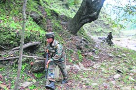 A jawan of 18 Dogra regiment takes cover during an encounter with militants at Mahoora, near the LoC, in the Uri sector of Baramulla district