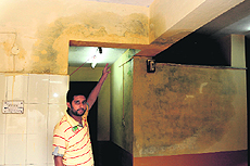 A hosteler shows a leaking roof at the Nehru Boys Hostel in Jammu University on Sunday. 