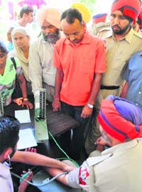 A policeman undergoes a check-up at a camp at the Police Lines in Ludhiana on Sunday