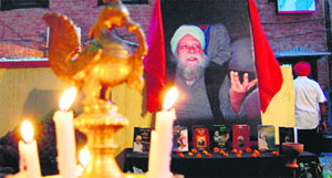 Fans light candles on Gursharan Singh's birth anniversary in Amritsar on Sunday.