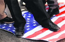 Protesters step on a US national flag during a protest in front of the US embassy in Ankara