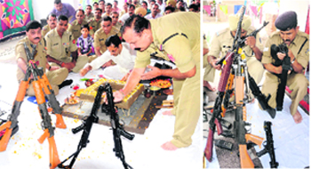 BSF officers and jawans worship their weapons during Vishwakarma Puja at Khassa Sector; and (right) CRPF personnel of 13th Battalion do so at a CRPF camp in Amritsar on Monday. Photos: Vishal Kumar