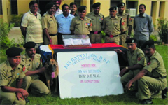 BSF officials along with three packets of heroin seized in Ferozepur. A Tribune photograph