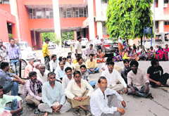 Employees stage a protest seeking compensation for next of kin of the deceased cyclist in Chandigarh on Monday. 