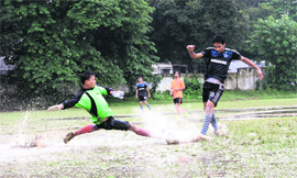 A rain-soaked match of the Dehradun district league being played at the Rangers College ground in Dehradun on Monday. 