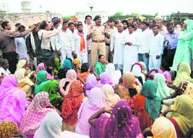 DSP Nirmal Singh assures protesters of a proper investigation into a case in front of the Kurukshetra City Police Station on Monday