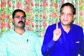 Industries Minister Kishan Kapoor (right) addresses mediapersons at Dharamsala on Monday