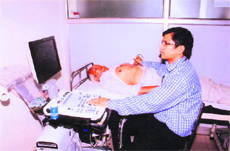 Dr Mukesh Joon examines a patient at a two-day free check-up camp in Sonepat. 
