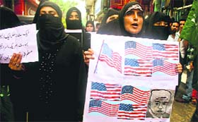 Members of the Muslim Khawateen Markaz raise anti-US and anti-Israeli slogans during a protest in Srinagar on Monday.