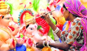 Ahead of Ganesh Chaturthi, an artist imparts finishing touches to Lord Ganesha idols in Jammu.