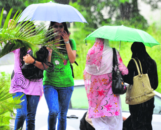 While rain caused chaos on city roads, these girl students seem to enjoy the drizzle at Jammu University on Monday.