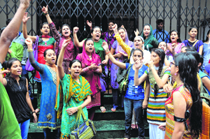 Students of the Institute of Music and Fine Arts demonstrate in front of the Vice-Chancellors office at Jammu University on Monday.
