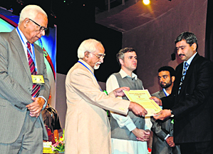Vice-President Mohammad Hamid Ansari honours a scientist during the inauguration of the 8th J&K Science Congress at Kashmir University in Srinagar on Monday.