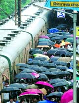 Office-goers board a train at Kolkatas Bidhannagar Road Station in on Monday.