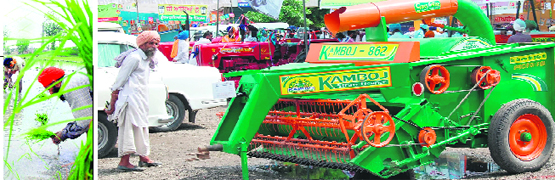 Wonder machine: A farmer looks at an agricultural machine with curiosity at a district-level Kisan Mela in Amritsar on Monday. Photo: Sameer Sehgal 