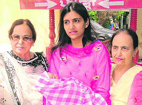Ritu Aggarwal (centre), wife of Deputy Commissioner Rajat Aggarwal, holds the abandoned baby in her arms at Red Cross Bhavan in Amritsar on Tuesday.