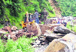 Boulders being cleared from a road at Ukhimath in Rudraprayag on Tuesday.