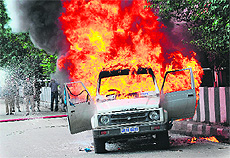 A government vehicle set ablaze by protesters in Srinagar on Tuesday. 