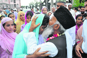 A man bids farewell to a relative leaving for the Haj pilgrimage (in Mecca) in Jammu on Tuesday. 