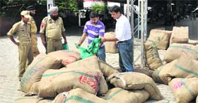The State Pollution Control Board officials inspect the seized polethene bags at Jammu Railway Station on Tuesday.